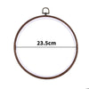 A circular wooden embroidery hoop with a dark metal hanger, measuring 23.5cm.