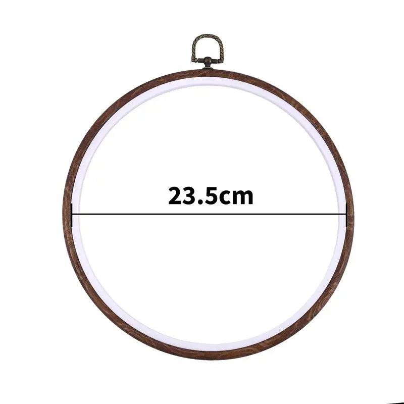 A circular wooden embroidery hoop with a dark metal hanger, measuring 23.5cm.