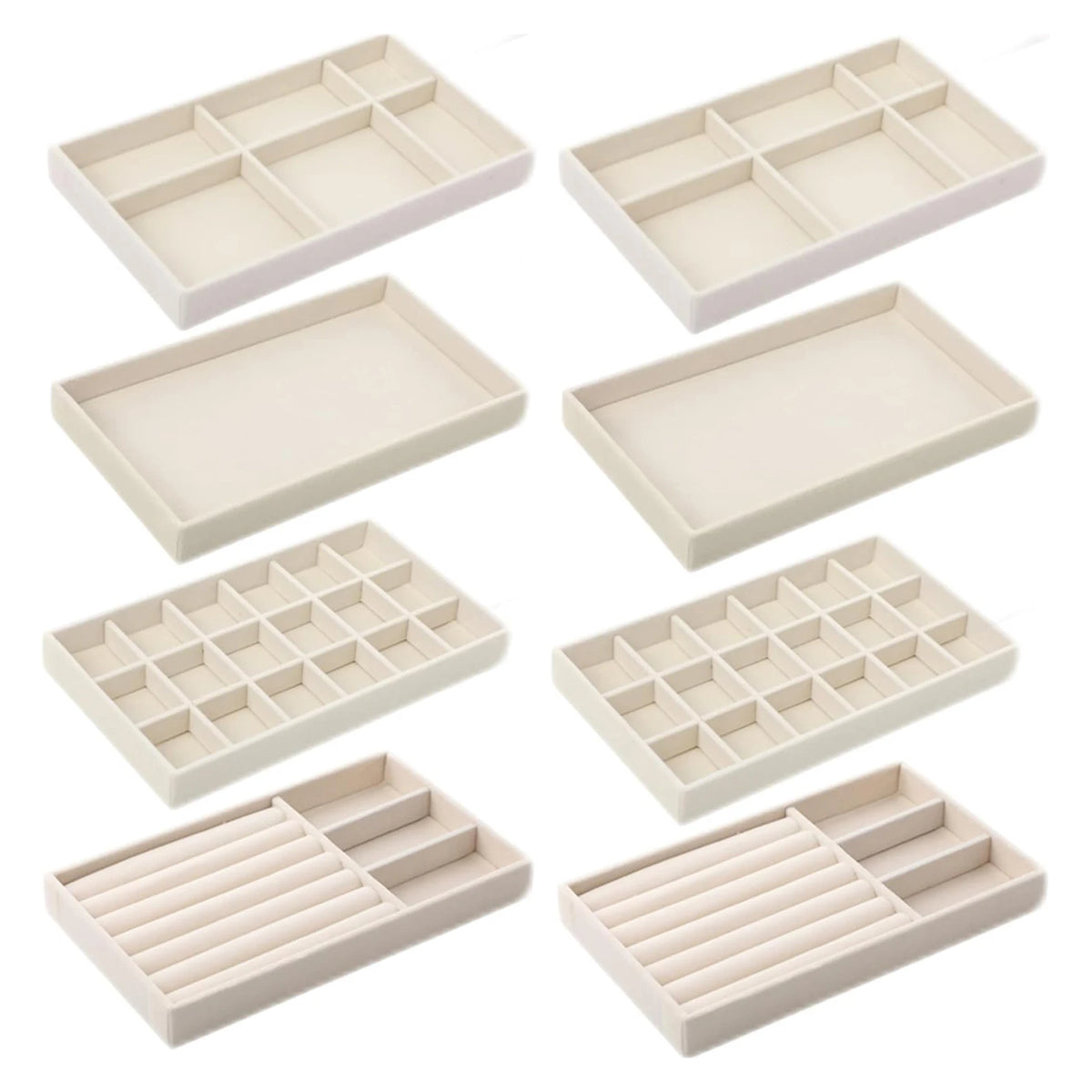 A set of light beige velvet jewelry organizer trays with various detachable compartments.