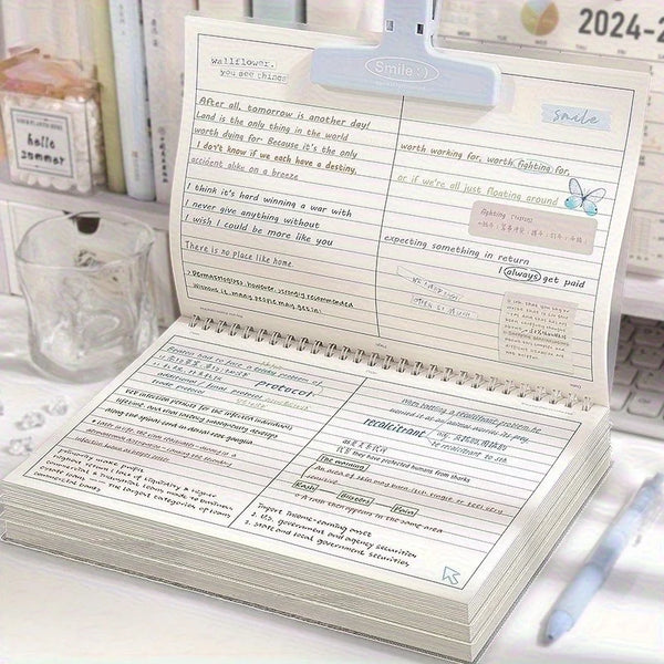 Cuaderno espiral flip-top tamaño B5 con papel rayado grueso y separadores de página, abierto en un escritorio.