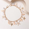 Gold chain necklace featuring starfish and pearl charms