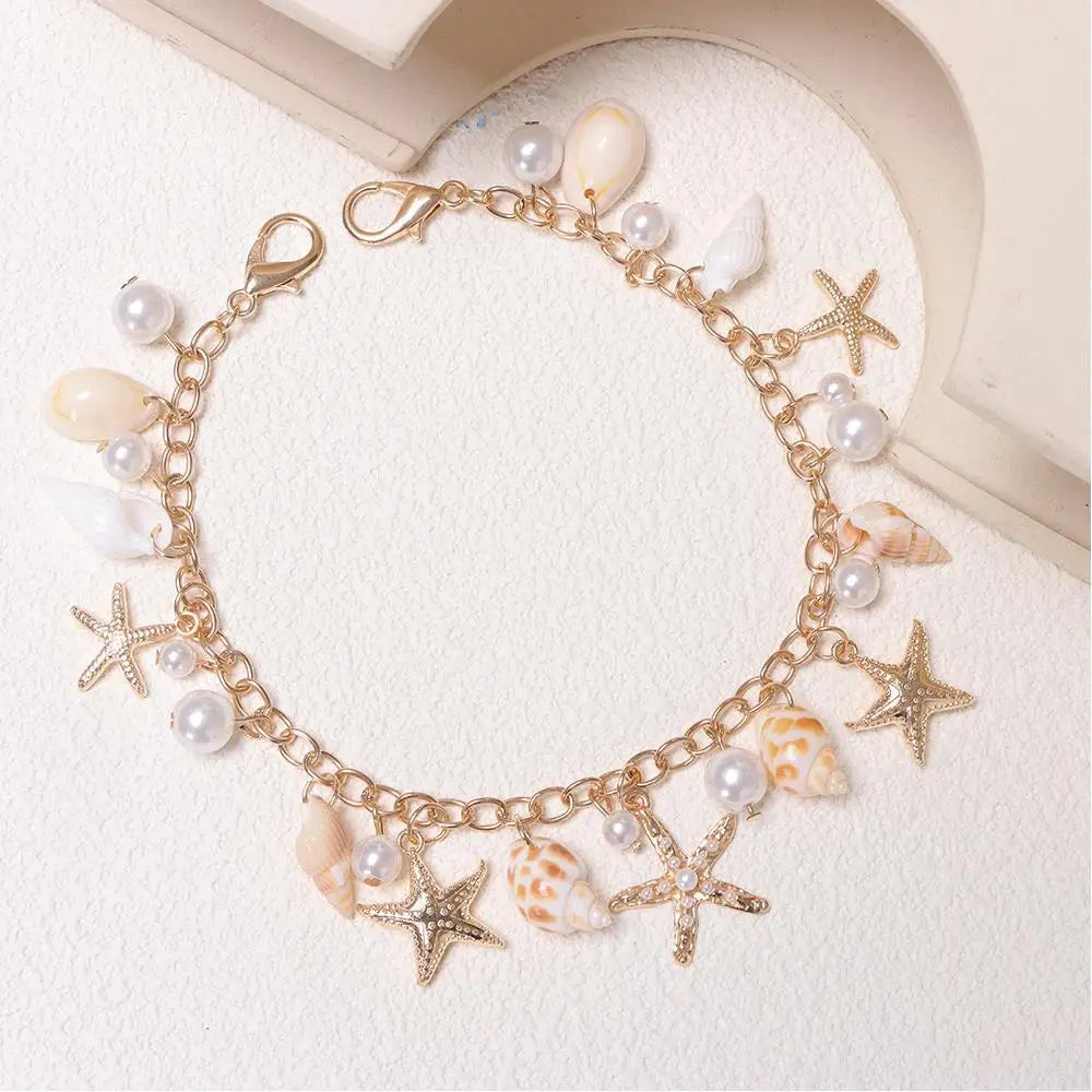 Gold chain necklace featuring starfish and pearl charms