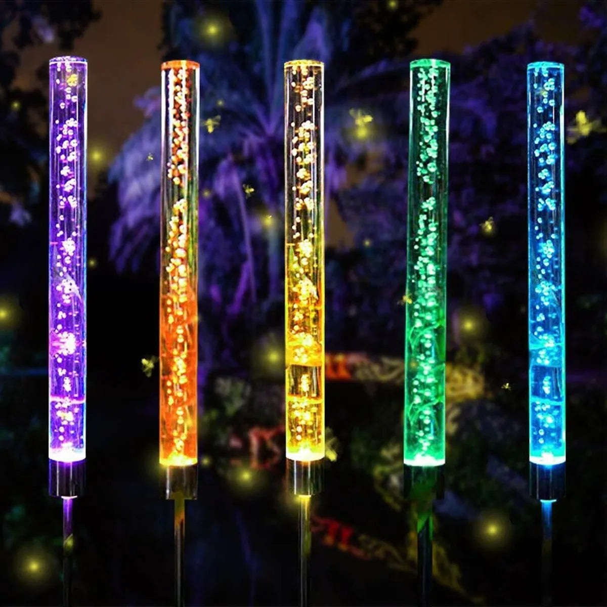 A vertical display of multiple color-changing LED lights in a garden setting.