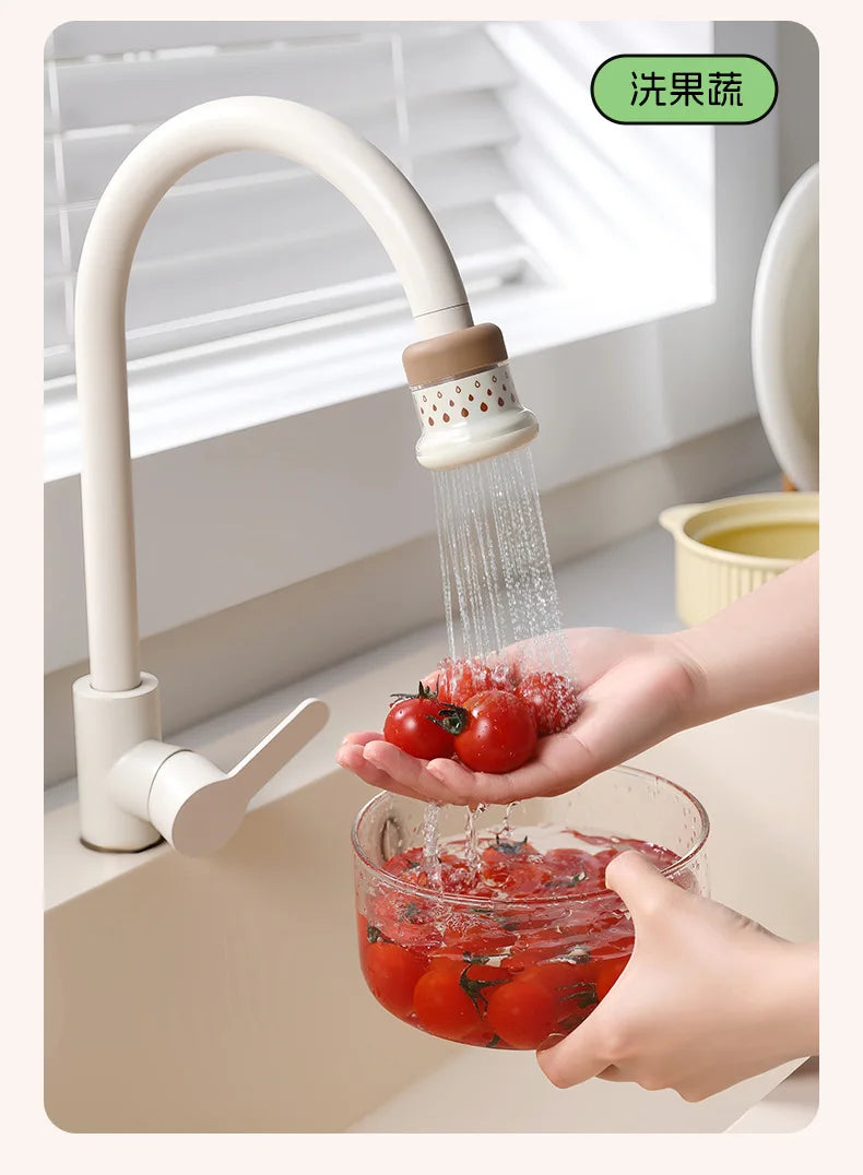 A kitchen faucet sprayer is shown spraying water onto fresh tomatoes.