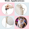 Close-up of heart-shaped spring hook keychains attached to a white quilted bag and a cat