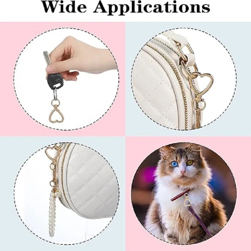 Close-up of heart-shaped spring hook keychains attached to a white quilted bag and a cat