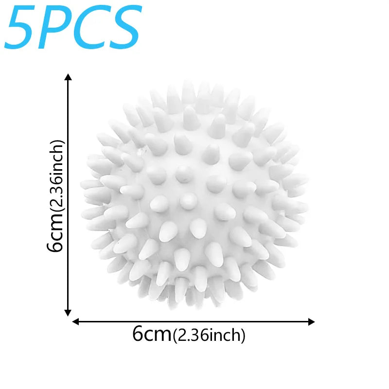 A spherical white laundry ball with numerous protrusions shown next to a measurement scale.