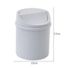 A white compact covered desktop trash bin with a flip lid.