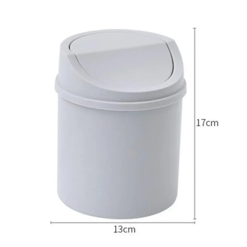 A white compact covered desktop trash bin with a flip lid.
