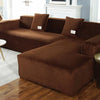 A plush brown velvet elastic sofa cover is shown on an L-shaped sectional sofa in a living room setting.