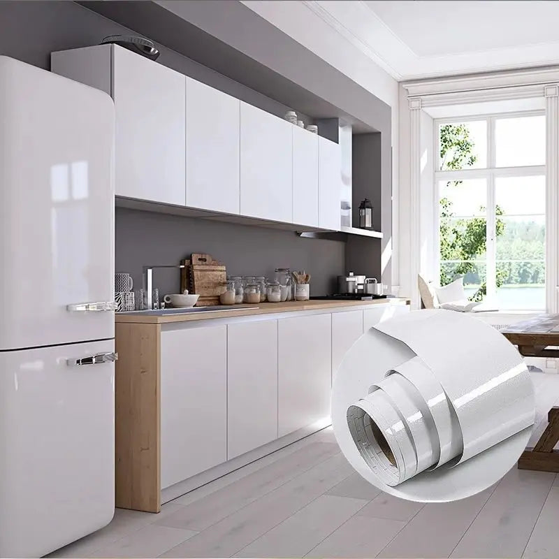 A roll of white marble wallpaper is displayed on a kitchen cabinet counter in a modern room.