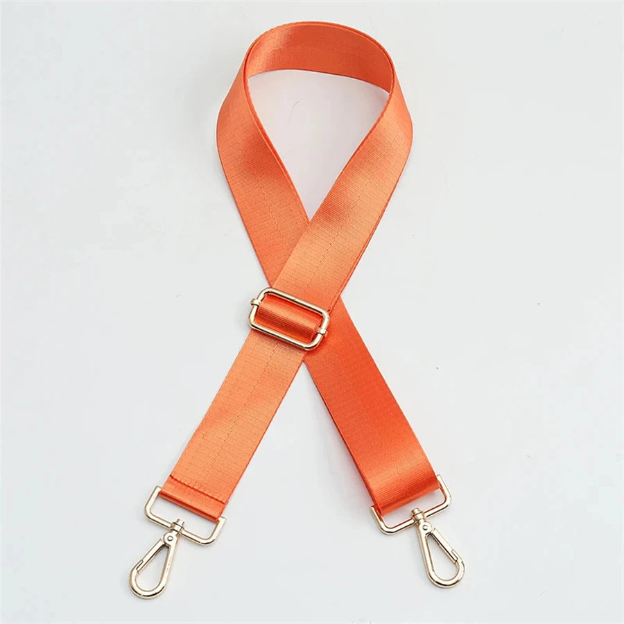 Orange nylon bag strap with a gold buckle and metal clasps