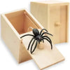 A wooden box with a pop-out mechanism revealing a black spider toy inside.