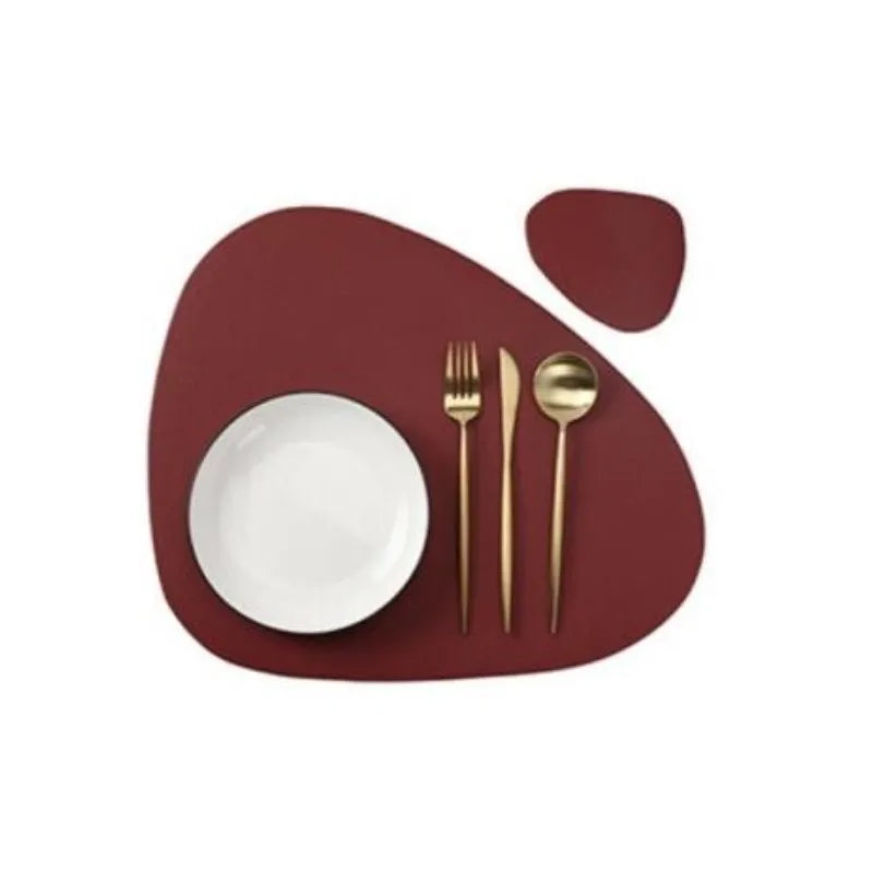 A set of reusable placemats featuring a white plate and gold cutlery on a maroon background.