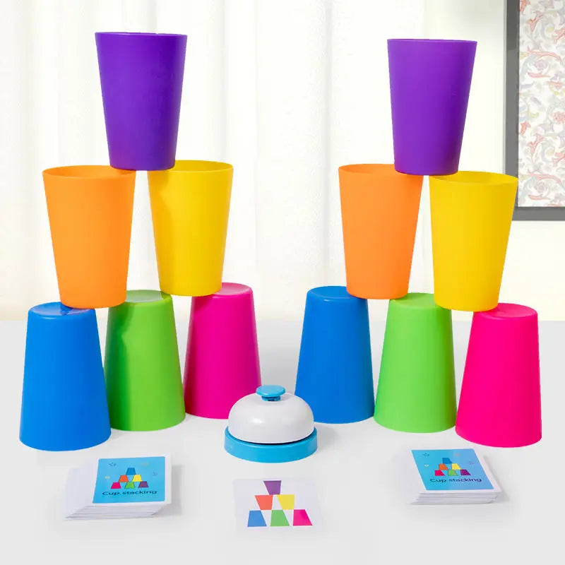A set of colorful plastic cups in purple, orange, yellow, and green are displayed with matching cards on a white table.