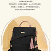 A black vegan leather backpack with pink accents and a laptop compartment shown from the front.