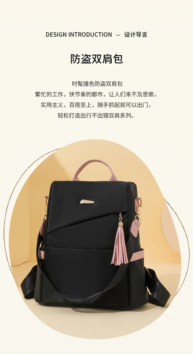 A black vegan leather backpack with pink accents and a laptop compartment shown from the front.