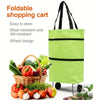 A lime green foldable shopping cart bag with black straps and wheels, shown next to fresh produce.