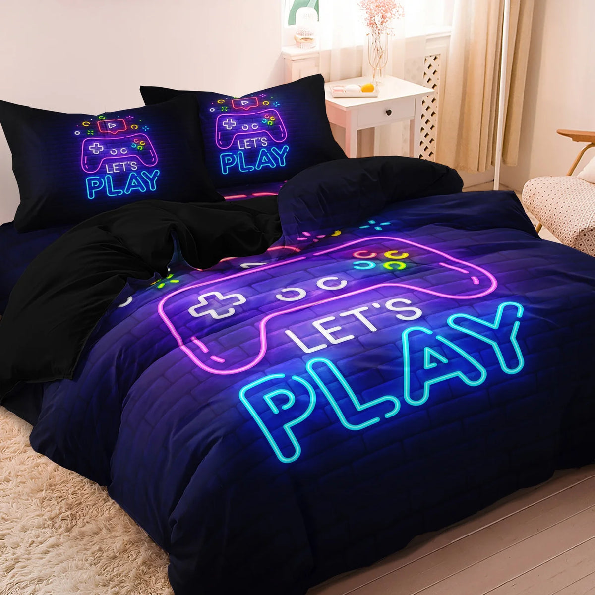 A dark blue duvet cover featuring a glowing purple video game controller design and the text LET'S PLAY.