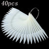 A fan-shaped clear acrylic false nail tips kit with numerous pointed tips.