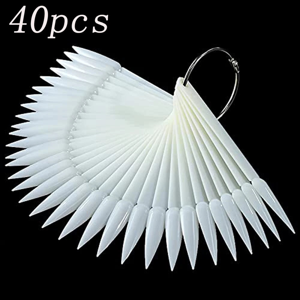 A fan-shaped clear acrylic false nail tips kit with numerous pointed tips.