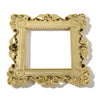 A rectangular gold resin light switch cover frame with ornate detailing.