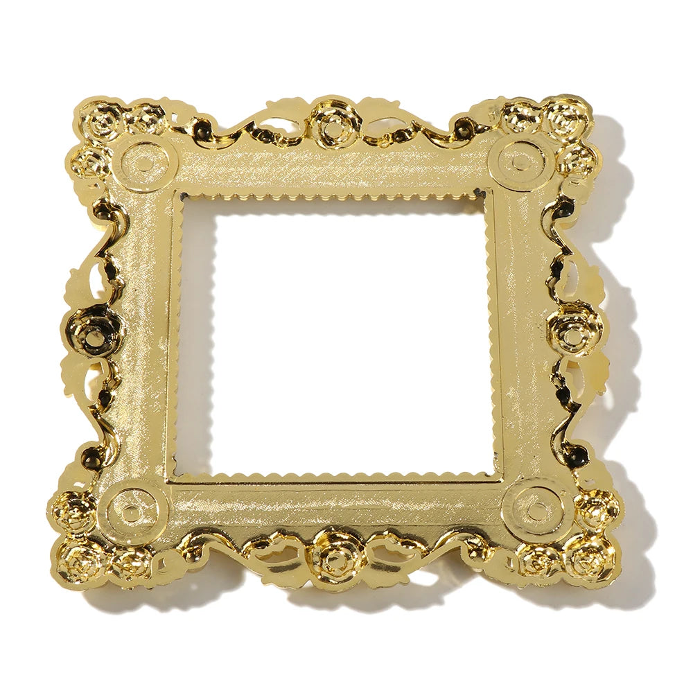 A rectangular gold resin light switch cover frame with ornate detailing.