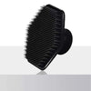 Black silicone body scrubber and massage brush shown from above