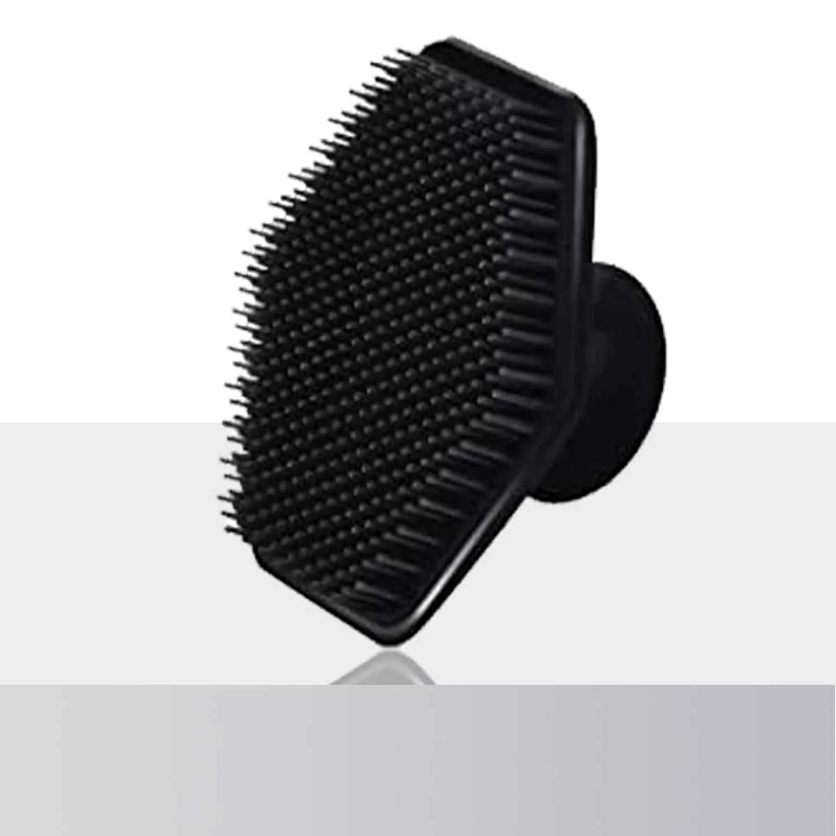 Black silicone body scrubber and massage brush shown from above