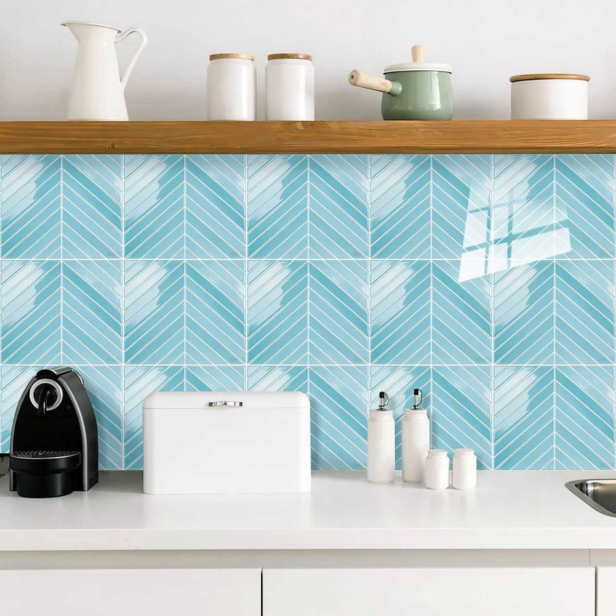White and blue herringbone marble peel-and-stick wall tiles displayed on a kitchen countertop.
