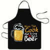 Black apron with yellow text that reads Kiss The Cook And Bring Him A Beer
