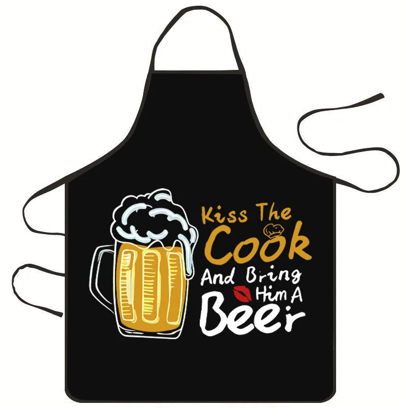 Black apron with yellow text that reads Kiss The Cook And Bring Him A Beer
