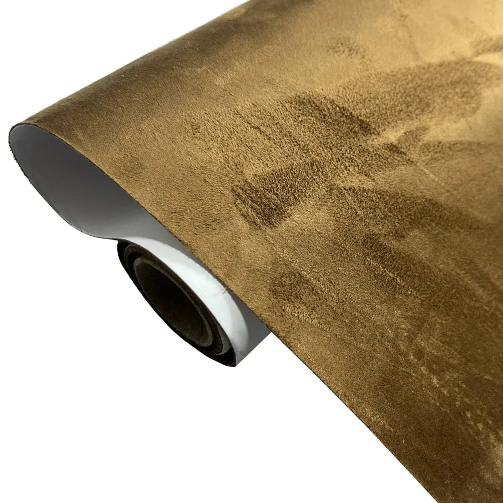 Roll of suede fabric in a golden brown color used for DIY interior and home decor projects.