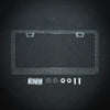 A clear crystal rhinestone license plate frame with mounting tabs and various rhinestone components.