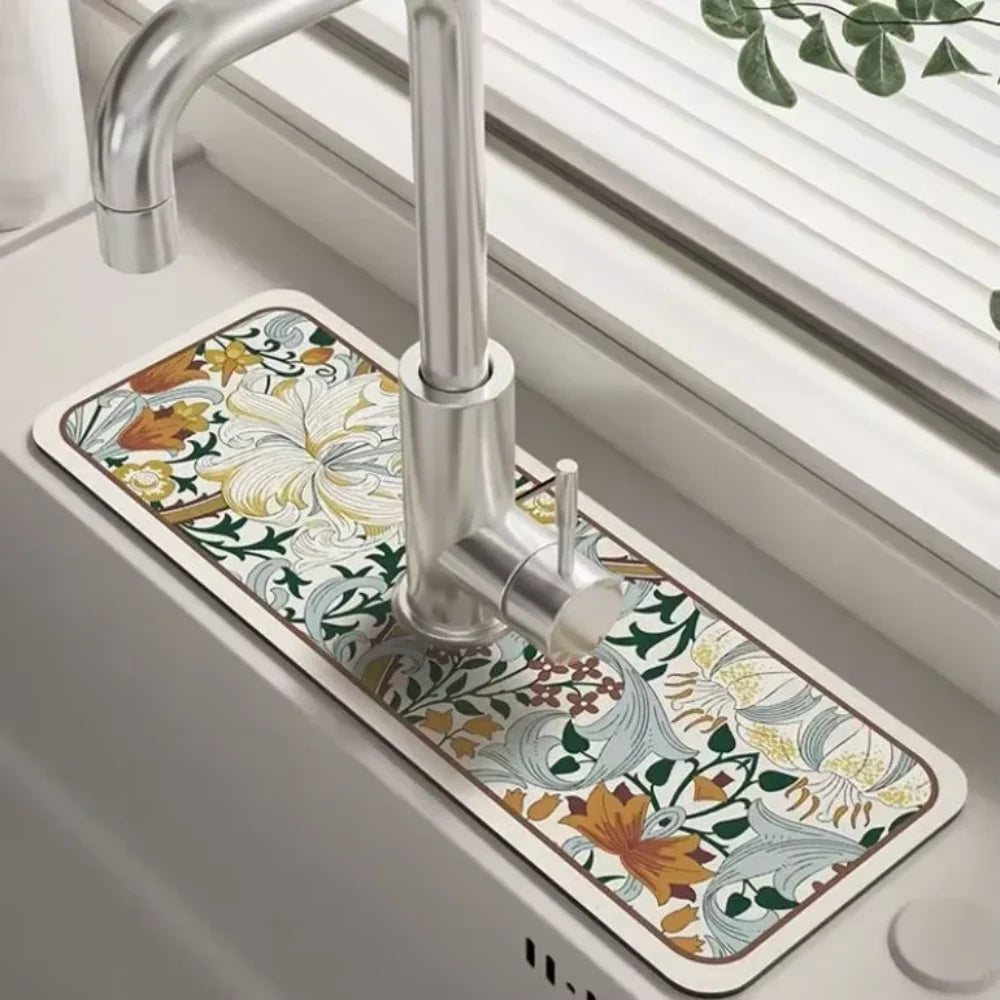 A silver faucet mounted on a rectangular mat with a floral pattern for a kitchen sink.