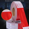 Rolls of reflective material tape with red and white stripes shown against a city skyline.