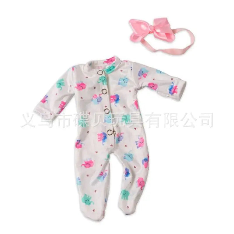White long-sleeved jumpsuit outfit for a baby doll with pink floral patterns and a pink bow