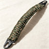 A close-up of a durable paracord handle with a metal hook, featuring a green and brown braided texture.