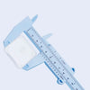 Light blue plastic vernier caliper tool with a white measuring block and scale markings.
