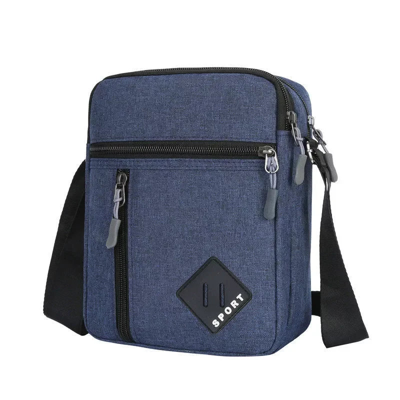 A navy blue lightweight crossbody sling bag with multiple zippered pockets and a black strap.