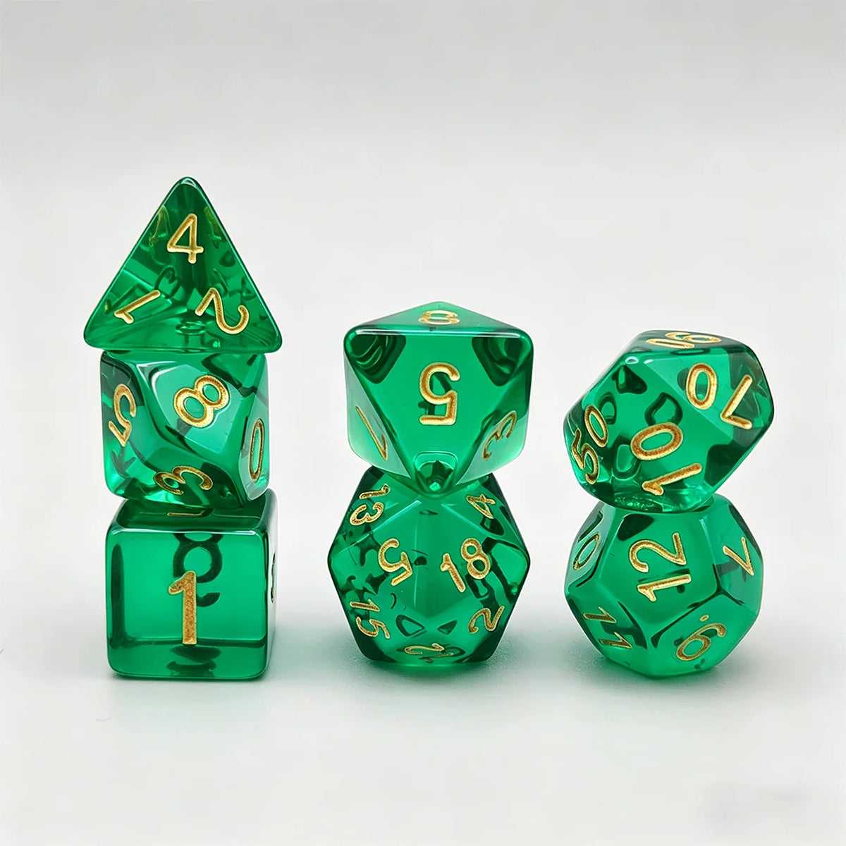 A set of seven translucent green acrylic polyhedral dice, including a tetrahedron and a dodecahedron.