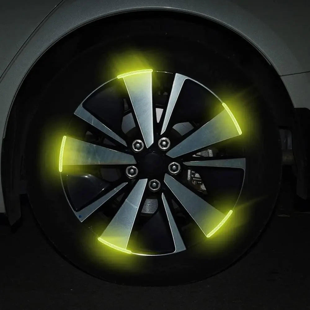 Close-up of a black wheel rim with bright yellow LED strips installed on the spokes.