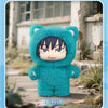 A plush doll of a cat-like character with dark hair and purple eyes, wearing a teal hoodie, displayed outdoors.
