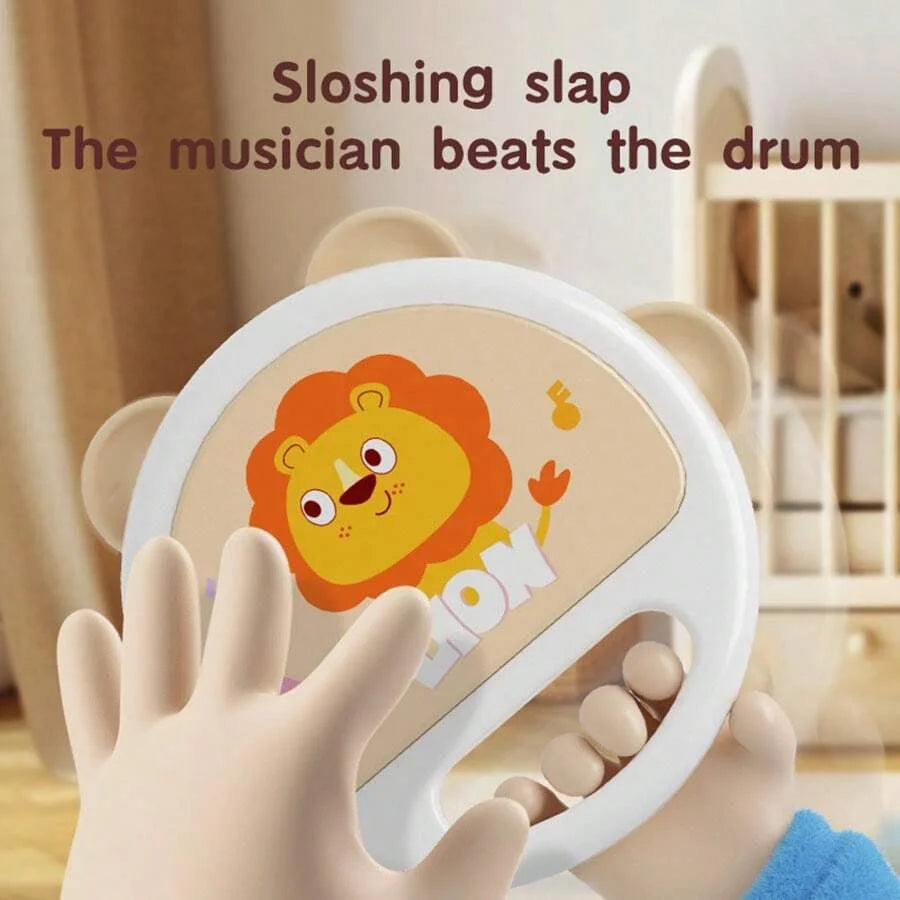 A child's hand is holding an animal-shaped clapping tambourine with a lion design.
