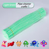 A bundle of light green pipe cleaners used for crafts, shown next to various small animal figures.