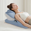 A woman is resting her eyes on a blue memory foam pillow designed for full-body support.