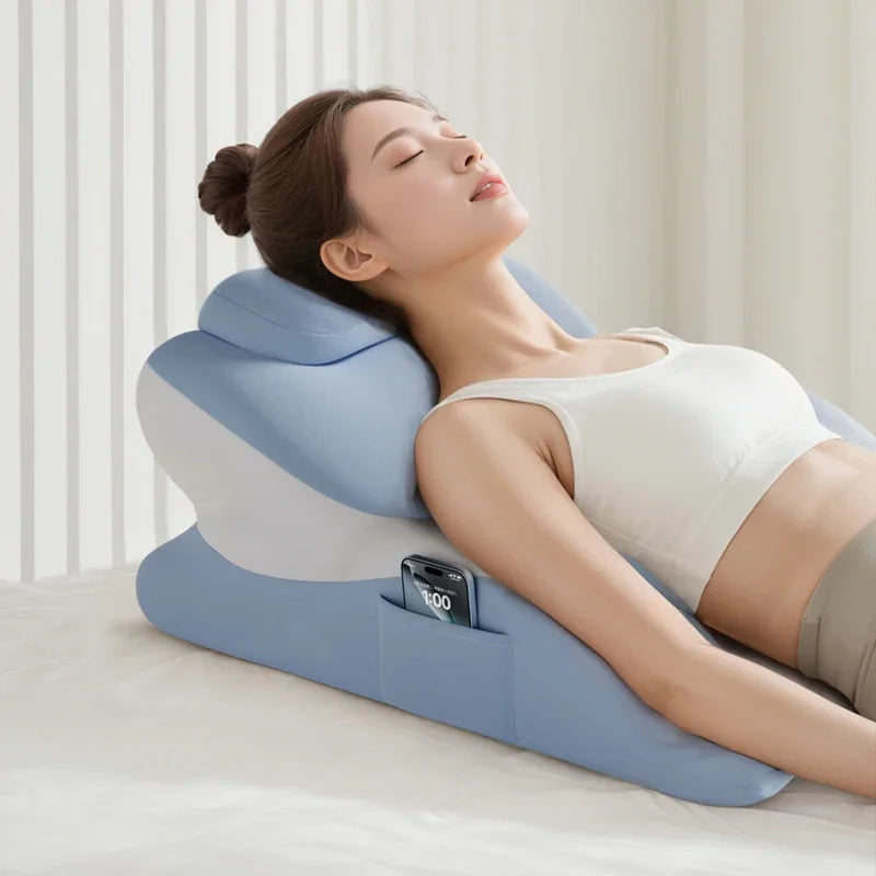 A woman is resting her eyes on a blue memory foam pillow designed for full-body support.