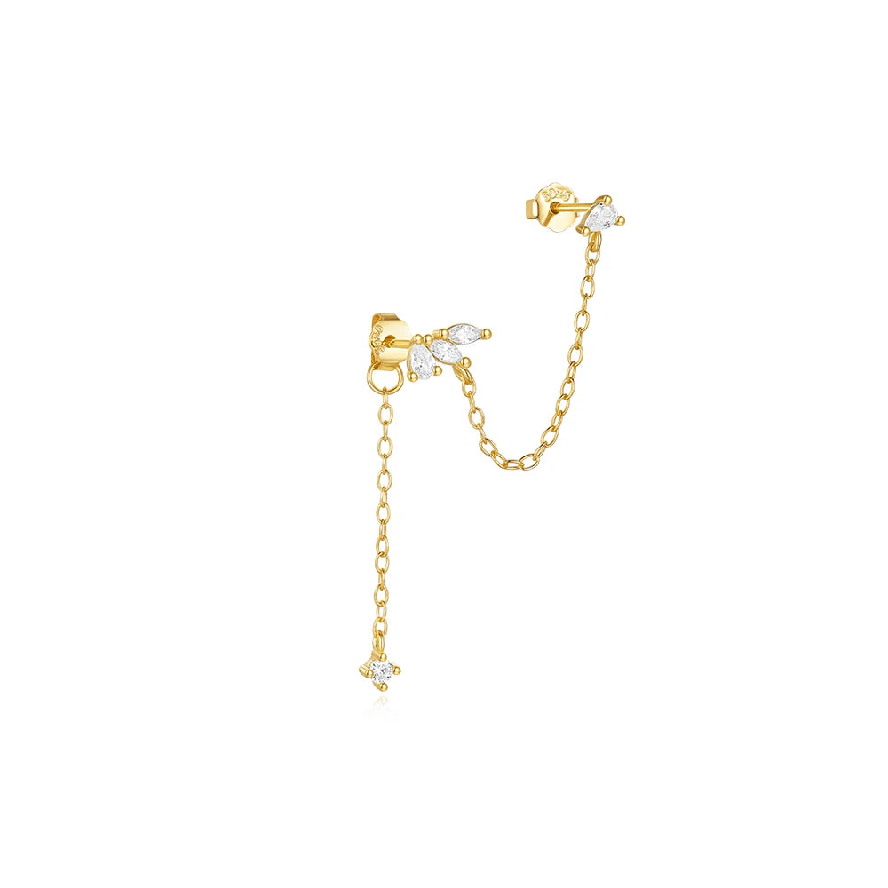 A gold-toned sterling silver ear cuff with a chain and a tassel design.