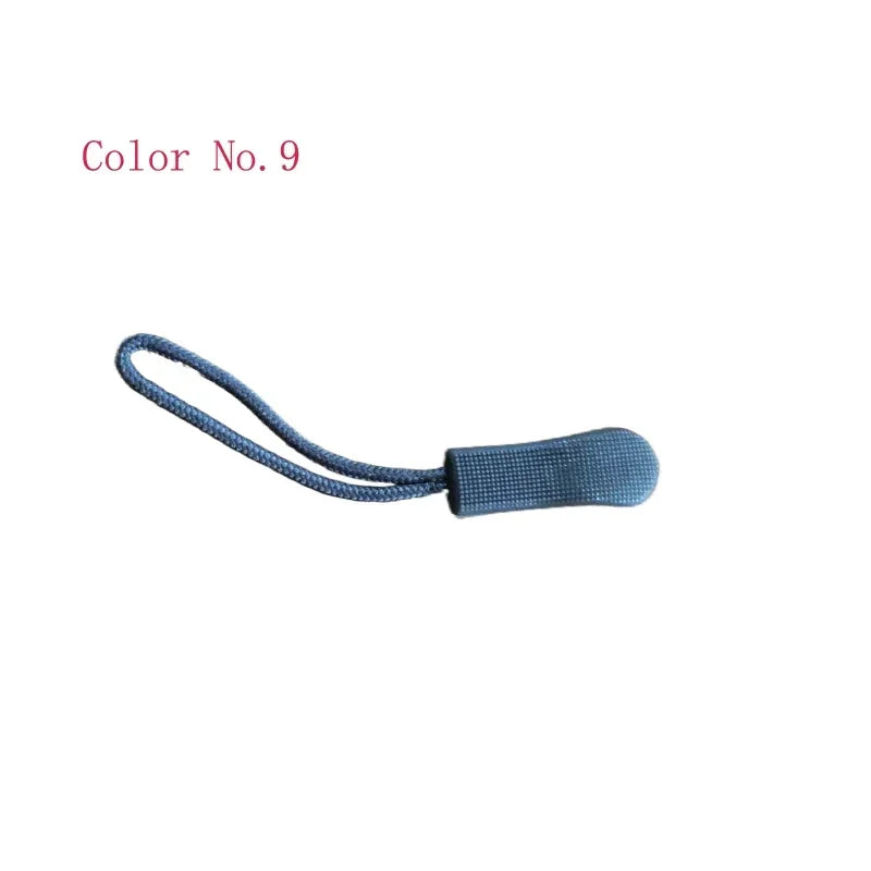 A close-up view of a blue plastic zipper pull with a thin cord attached.