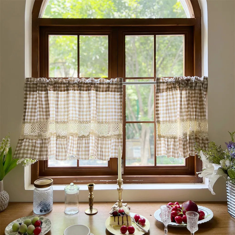 Beige gingham cafe curtain with crochet lace trim hanging in a wooden window frame.